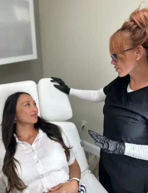 Mindy Jackson explaining Botox procedure to patient in the aesthetics room
