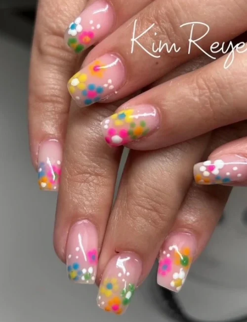 Close up of clients fresh hard gel nails with hand painted floral designs