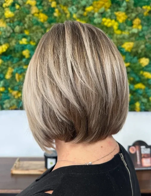 Back of a woman's head, showcasing her new hair cut and blonde color at EDEN Spa Suites