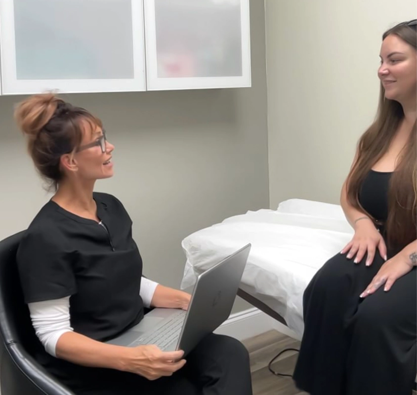 Mindy Jackson in a consult with a patient in the EDEN Aesthetics room